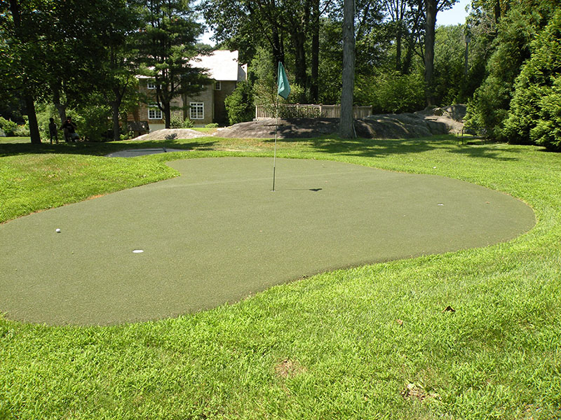 picturesque putting green with house in background
