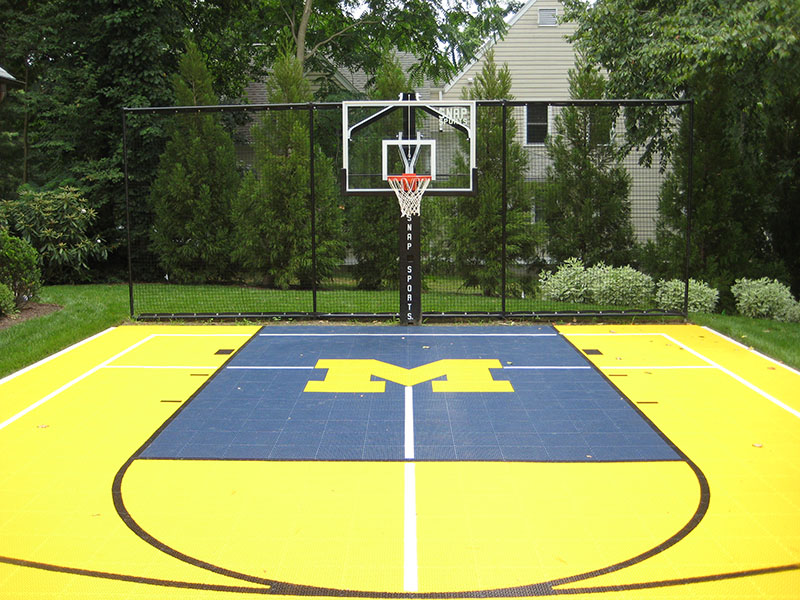  outdoor michigan style basketball court in backyard
